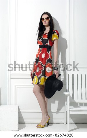 full-length fashion model in fashion dress posing in the studio