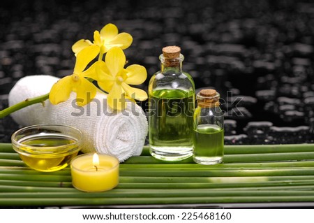 spa concept orchid and candle,oil,towel with row of plant stem