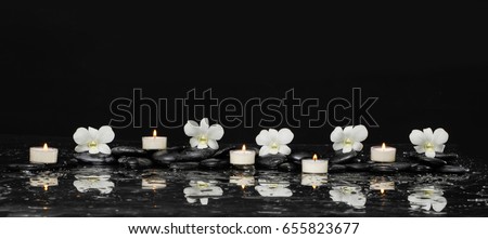 still life with pebbles and five white orchid,candle