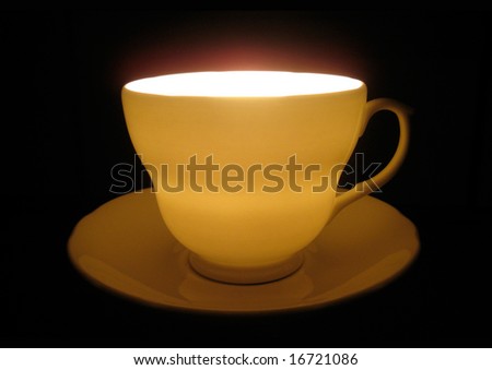 an indoor shoot of a cup, very close up angle view. dark background.