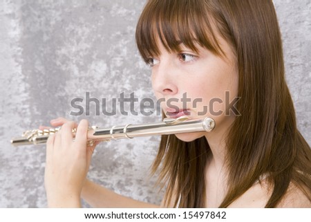 Close up of a teenager girl playing flute