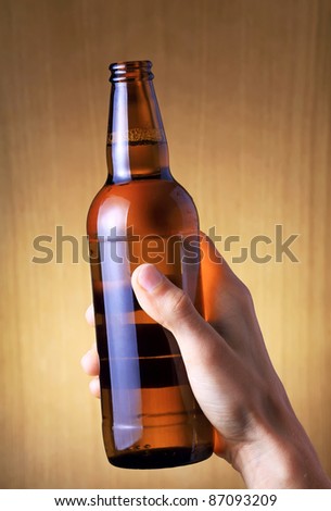 The bottle of beer in hand