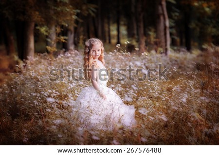 Little cute girl walking in the woods.  Summer, sunlight, portrait, warm, forest.