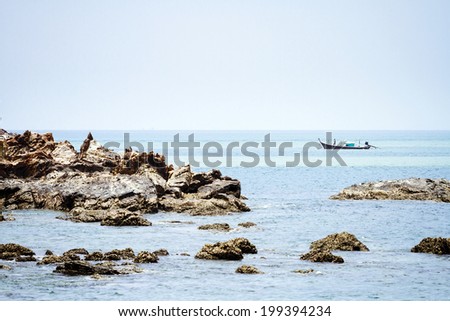 sea rock stone and fishing boat