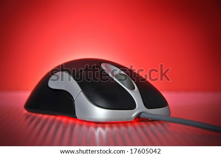 Black and Silver Wired Optical Computer Mouse on Red Background