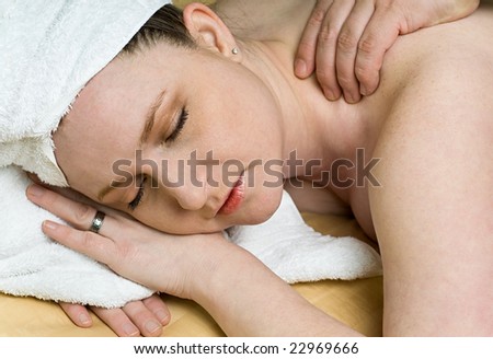 Beautiful Salon Woman Getting Relaxing Massage Therapy at Day Spa