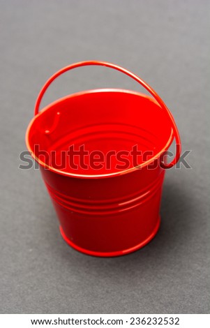 Red metal Bucket on grey background