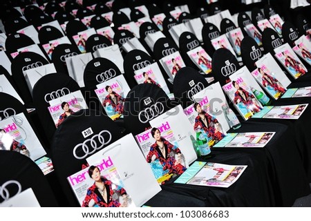 SINGAPORE - MAY 18: Audience seats with Her World magazine and Swarovski goody bags at Audi Fashion Festival 2012 on May 18, 2012 in Singapore