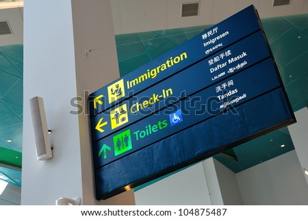 Immigration, check-in and toilet signs in Marina Bay Cruise Center Singapore in 4 languages