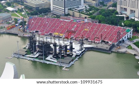 SINGAPORE - AUGUST 04: Sea of audience dressed in red to celebrate Singapore\'s National Day 2012 at the Marina Bay Floating Platform on August 04, 2012 in Singapore