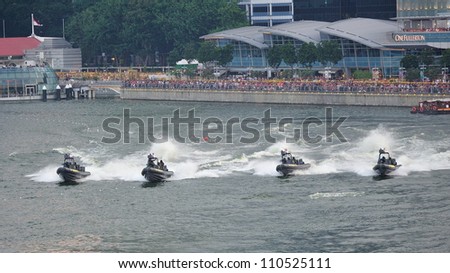 SINGAPORE - AUGUST 09: Republic of Singapore Navy assault boats giving chase during National Day Parade 2012 on August 09, 2012 in Singapore