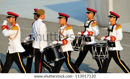 SINGAPORE - AUGUST 09: Military band drumming to the Parade Commander LTC Clarence Tan during National Day Parade 2012 on August 09, 2012 in Singapore