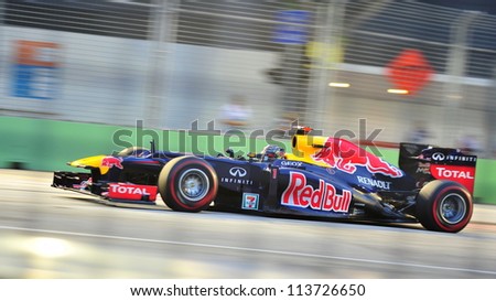 SINGAPORE - SEPTEMBER 22: Sebastian Vettel racing in his Red Bull Racing car during 2012 Formula 1 Singtel Singapore Grand Prix on September 22, 2012 in Singapore