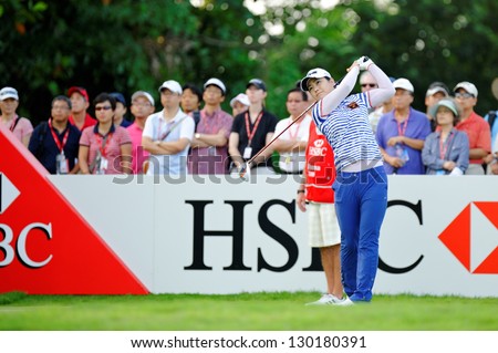 SINGAPORE - MARCH 2: Korean player Meena Lee swinging her club at the 1st tee box at HSBC Women's Champions at Sentosa Golf Club Serapong Course March 2, 2013 in Singapore