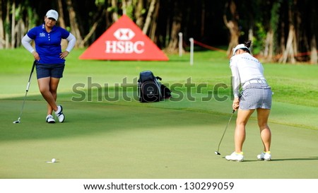 SINGAPORE - MARCH 2: Japanese Chie Arimura putting at the green during HSBC Women's Champions at Sentosa Golf Club Serapong Course March 2, 2013 in Singapore