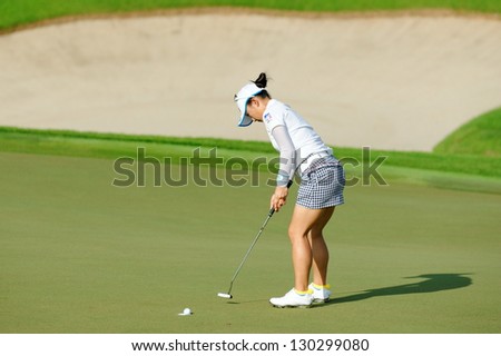 SINGAPORE - MARCH 2: Japanese Chie Arimura putting at the green during HSBC Women\'s Champions at Sentosa Golf Club Serapong Course March 2, 2013 in Singapore
