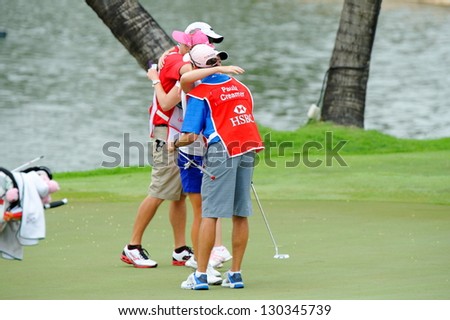 SINGAPORE - MARCH 3: American Stacy Lewis hugging Paula's caddie as she won the HSBC Women's Champions at Sentosa Golf Club Serapong Course March 3, 2013 in Singapore