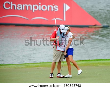 SINGAPORE - MARCH 3: American Stacy Lewis hugged by caddie Travis Wilson as she won the HSBC Women\'s Champions at Sentosa Golf Club Serapong Course March 3, 2013 in Singapore