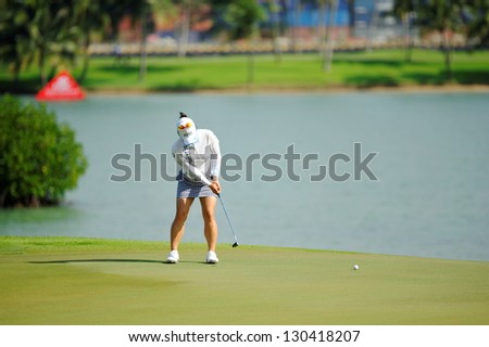 SINGAPORE - MARCH 2: Japanese Chie Arimura putting at the green during HSBC Women's Champions at Sentosa Golf Club Serapong Course March 2, 2013 in Singapore