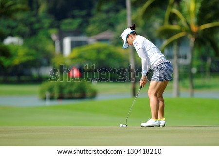 SINGAPORE - MARCH 2: Japanese Chie Arimura putting at the green during HSBC Women\'s Champions at Sentosa Golf Club Serapong Course March 2, 2013 in Singapore