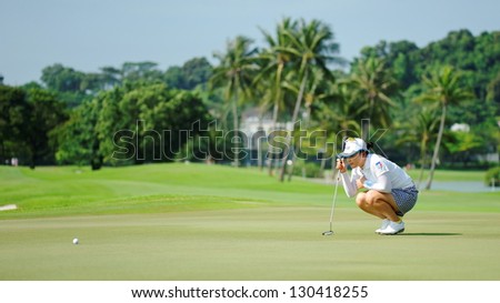 SINGAPORE - MARCH 2: Japanese Chie Arimura studying the ball path during HSBC Women\'s Champions at Sentosa Golf Club Serapong Course March 2, 2013 in Singapore