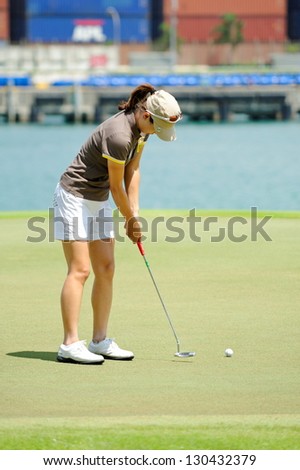 SINGAPORE - MARCH 2: Korean Sun Young Yoo putting at the green during HSBC Women\'s Champions at Sentosa Golf Club Serapong Course March 2, 2013 in Singapore