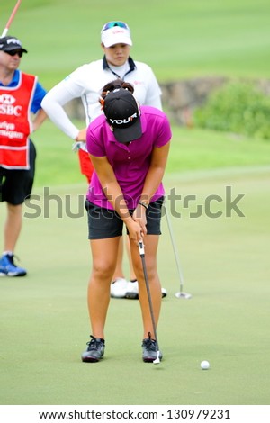 SINGAPORE - MARCH 3: American Danielle Kang putting at the green during HSBC Women\'s Champions at Sentosa Golf Club Serapong Course March 3, 2013 in Singapore