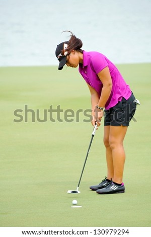 SINGAPORE - MARCH 3: American Danielle Kang putting at the green during HSBC Women\'s Champions at Sentosa Golf Club Serapong Course March 3, 2013 in Singapore