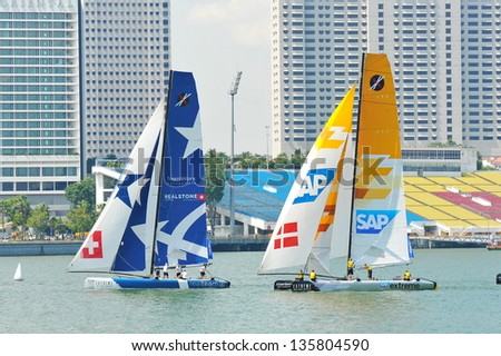SINGAPORE - APRIL 13: Realteam racing SAP Extreme Sailing team at the Extreme Sailing Series race at Marina Bay Reservoir April 13, 2013 in Singapore