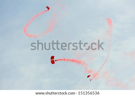 SINGAPORE - JULY 20: The Red Lions sky diving during National Day Parade (NDP) Rehearsal 2013 on July 20, 2013 in Singapore
