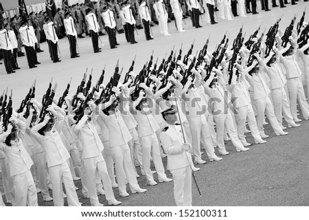 SINGAPORE - JULY 20: Guard-of-honor contingents executing feu de joie during National Day Parade (NDP) Rehearsal 2013 on July 20, 2013 in Singapore