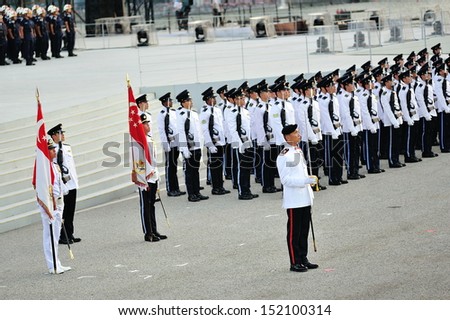 SINGAPORE - JULY 20: Parade Commander standing smartly with the guard-of-honor contingents during National Day Parade (NDP) Rehearsal 2013 on July 20, 2013 in Singapore