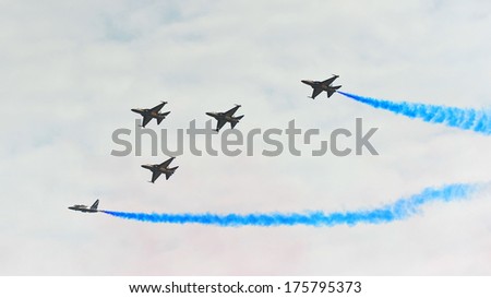 SINGAPORE - FEBRUARY 9: Aerobatic flying display by Black Eagles from the Republic of Korean Air Force (ROKAF) at Singapore Airshow February 9, 2014 in Singapore