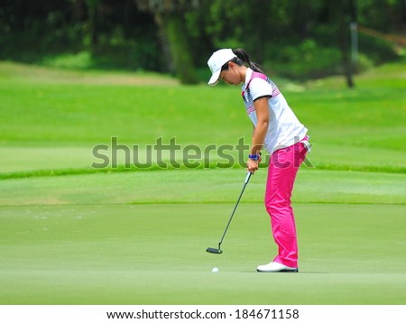 SINGAPORE - MARCH 2: Xiyu Lin putting at the green during HSBC Women\'s Champions at Sentosa Golf Club Serapong Course March 2, 2014 in Singapore