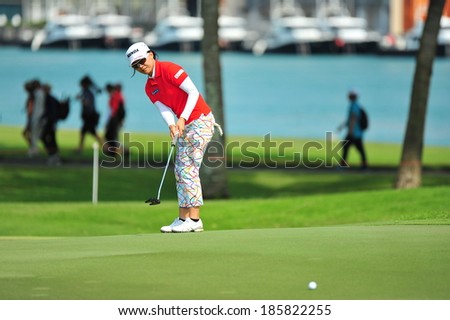 SINGAPORE - MARCH 2: Taiwanese player Teresa Lu putting on the green during HSBC Women's Champions at Sentosa Golf Club Serapong Course March 2, 2014 in Singapore