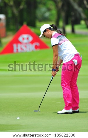 SINGAPORE - MARCH 2: Xiyu Lin putting at the green during HSBC Women\'s Champions at Sentosa Golf Club Serapong Course March 2, 2014 in Singapore