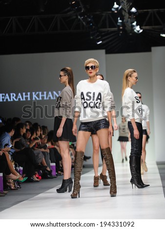 Singapore - May 16: Model showcasing fall/winter designs from Farah Khan at Audi Fashion Festival 2014 on May 16, 2014 in Singapore