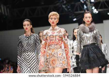 Singapore - May 16: Models showcasing fall/winter designs from Farah Khan at Audi Fashion Festival 2014 on May 16, 2014 in Singapore