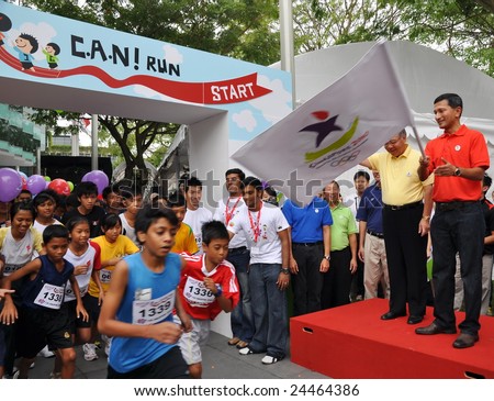 SINGAPORE - JANUARY 10: Minister Vivian Balakrishnan flagging off a run at the launch of the Singapore 2010 Youth Olympic Games logo January 10, 2009 in Singapore