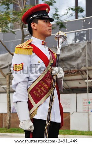SINGAPORE - DECEMBER 07: Singapore Armed Forces Band B drum major holding mace during President\'s changing-of-guards parade December 07, 2008 in Singapore