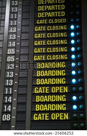 Airport departure information board showing check-in rows and boarding status