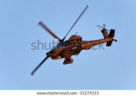 SINGAPORE - JULY 25: An Apache attack helicopter performs a stunt during Singapore National Day Parade 2009 combined rehearsal July 25, 2009 in Singapore