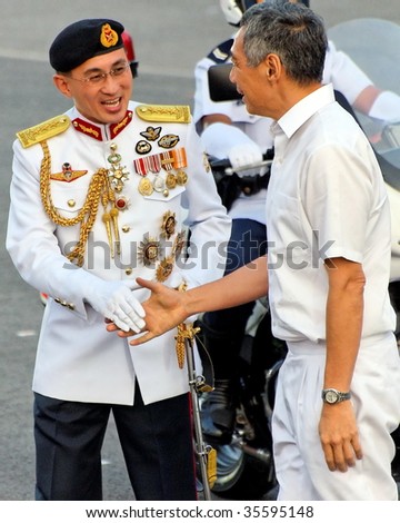 SINGAPORE - AUGUST 09: Chief Defense Force LG Desmond Kuek welcomes Prime Minister Lee Hsien Loong during Singapore National Day Parade 2009 August 09, 2009 in Singapore
