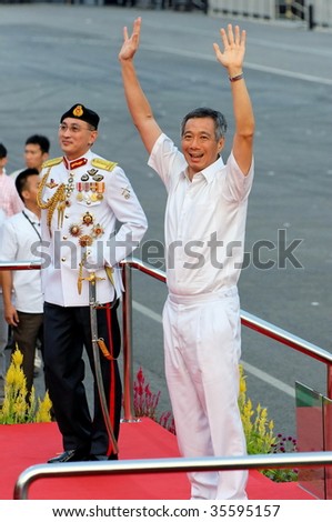 SINGAPORE - AUGUST 09: Prime Minister Lee Hsien Loong waving to audience during Singapore National Day Parade 2009 August 09, 2009 in Singapore