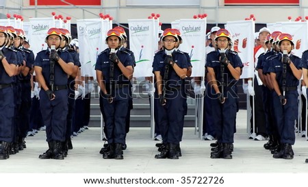 SINGAPORE - AUGUST 09: Civil Defense contingent saluting during Singapore National Day Parade 2009 August 09, 2009 in Singapore