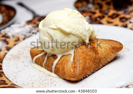 Home-made apple strudel topped with vanilla ice-cream