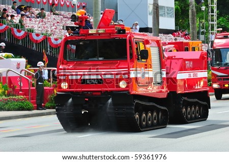 SINGAPORE - AUGUST 09: Tracked fire fighting vehicle parading during Singapore National Day Parade 2010 at the Padang August 09, 2010 in Singapore