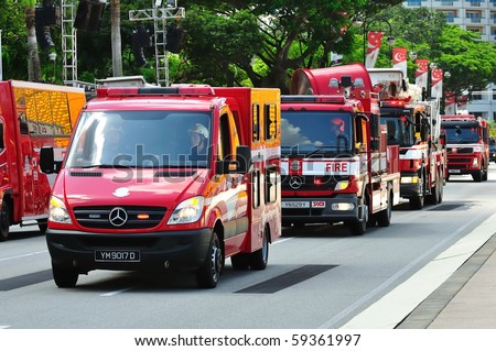 SINGAPORE - AUGUST 09: Row of emergency vehicles parading during Singapore National Day Parade 2010 at the Padang August 09, 2010 in Singapore