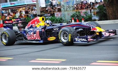 SINGAPORE - APRIL 24: David Coulthard driving the Red Bull Racing F1 car RB6 to perform stunts during Red Bull Speed Street Singapore on April 24, 2011 in Singapore.