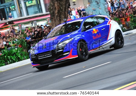 SINGAPORE - APRIL 24: Red Bull Racing Renault Megane sports hatch performing stunts during Red Bull Speed Street Singapore on April 24, 2011 in Singapore.